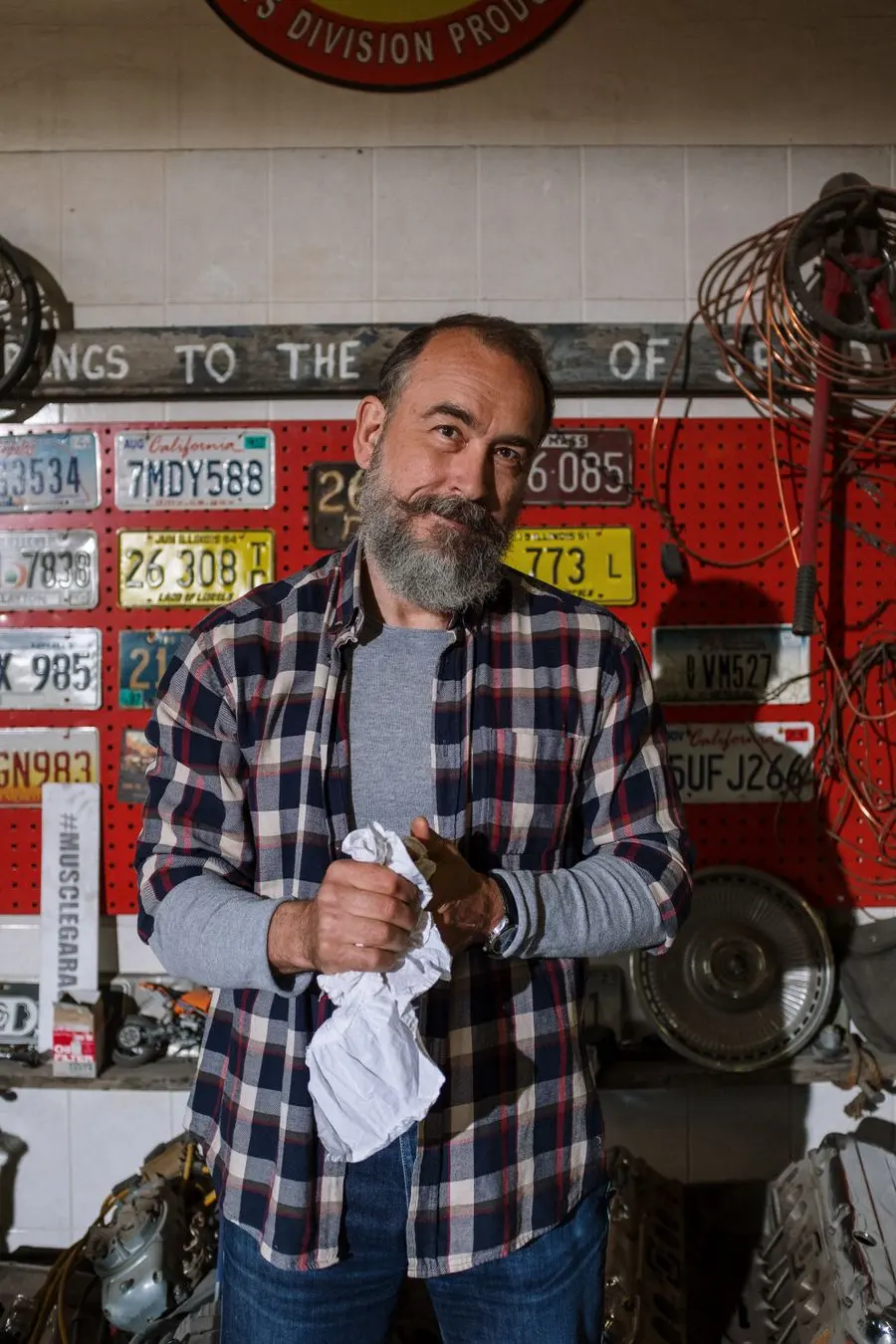 A mechanic standing in his garage