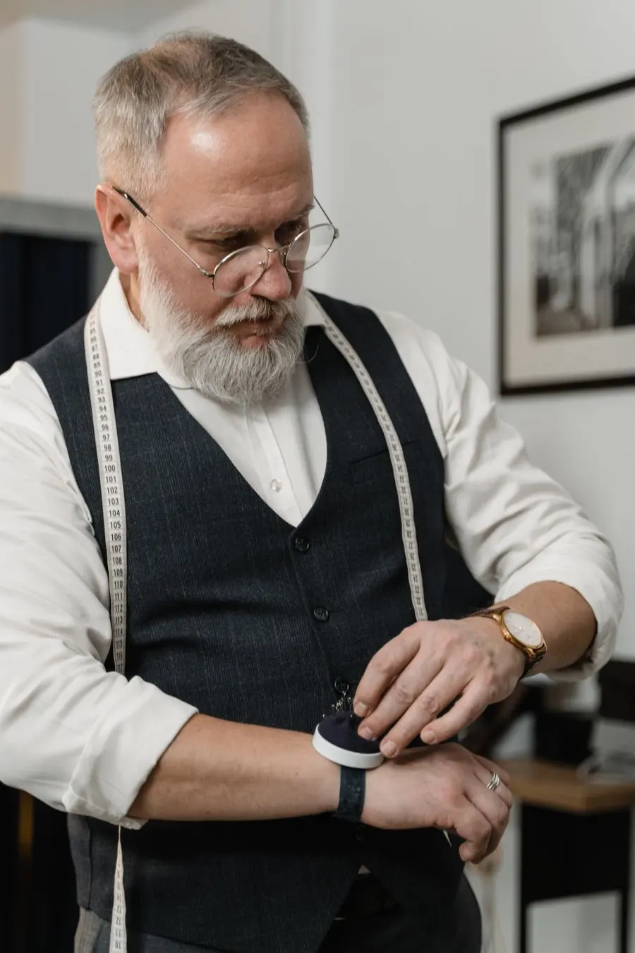 A tailor in a vest working in his studio
