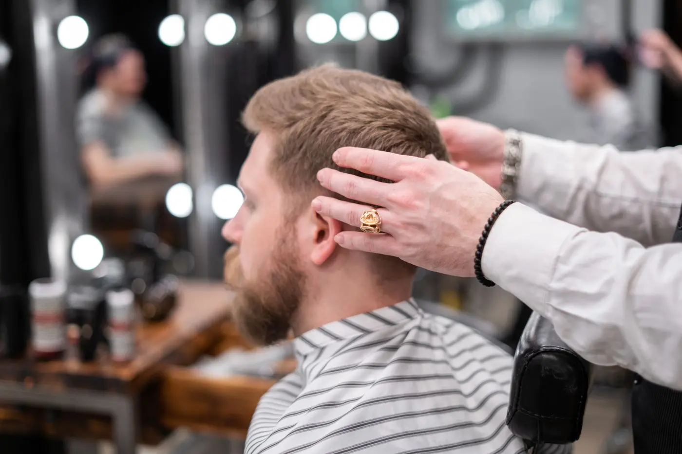 A barber styling a customer’s hair